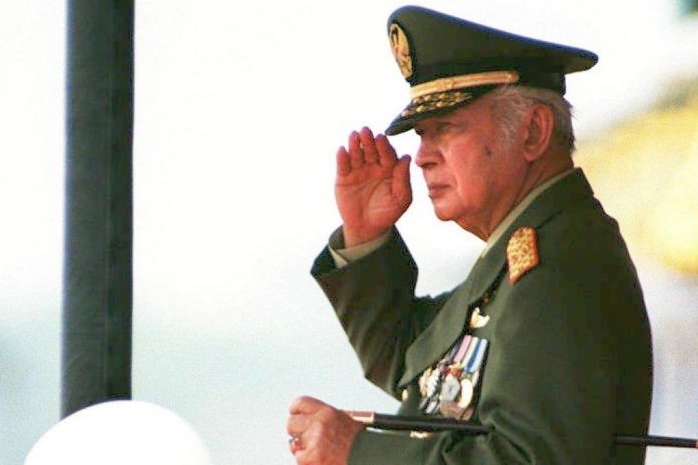 Indonesian President Suharto, in full military uniform, salutes an armed forces’ parade on October 5, 1997. Photo: AFP
