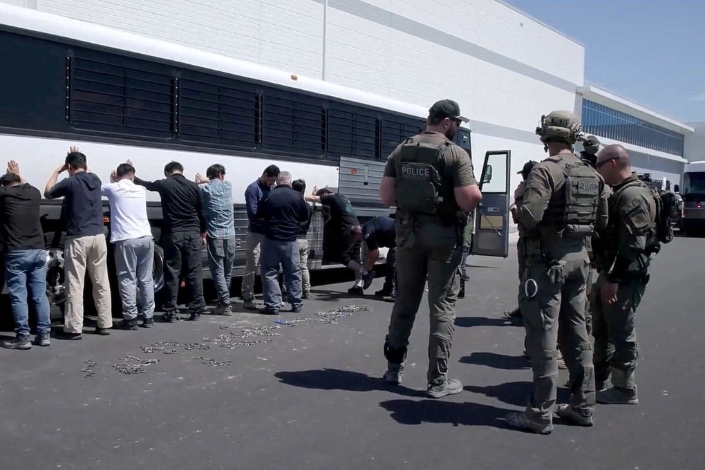 Detainees are made to stand against a bus before being handcuffed, during a raid by federal agents in Ellabell, Georgia, in September. Photo: US Immigration and Customs Enforcement/Reuters