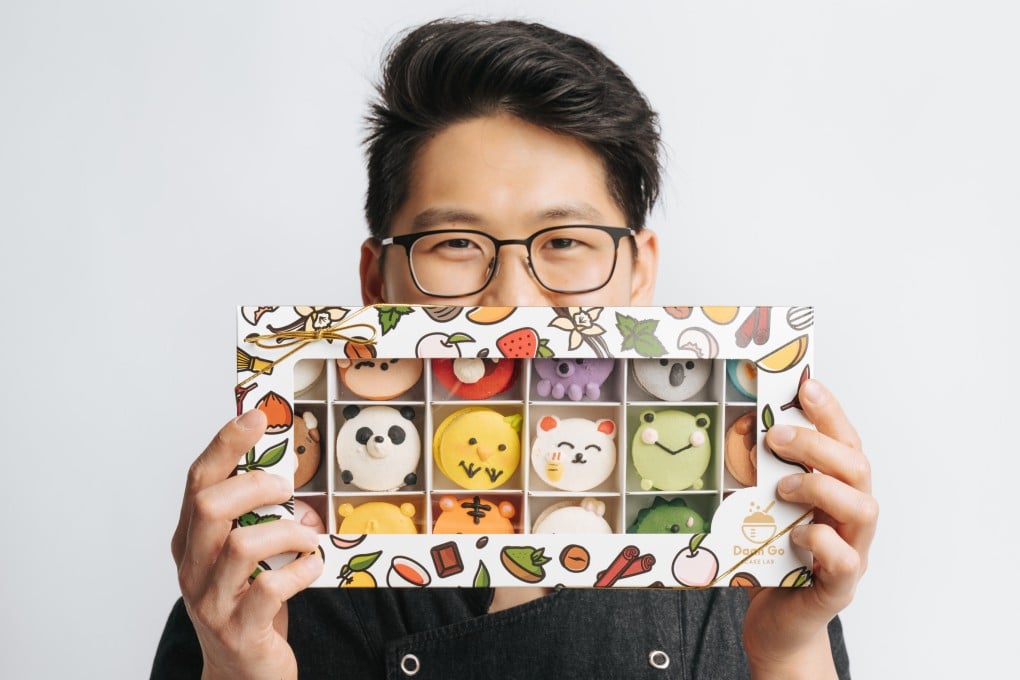 Chris Siu holds desserts from his bakery, Daan Go Cake Lab, which now has several branches across Canada. Siu was eliminated in the quarter-finals of MasterChef Canada season two in 2015, but tried again years later and won. Photo: White Book Studio