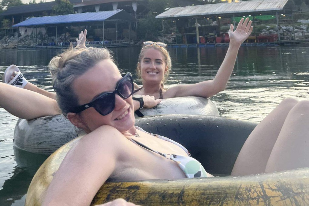 Bethany Clarke (front) and Simone White tube down a river in Laos on November 12 last year. Photo: Facebook/Bethany Clarke