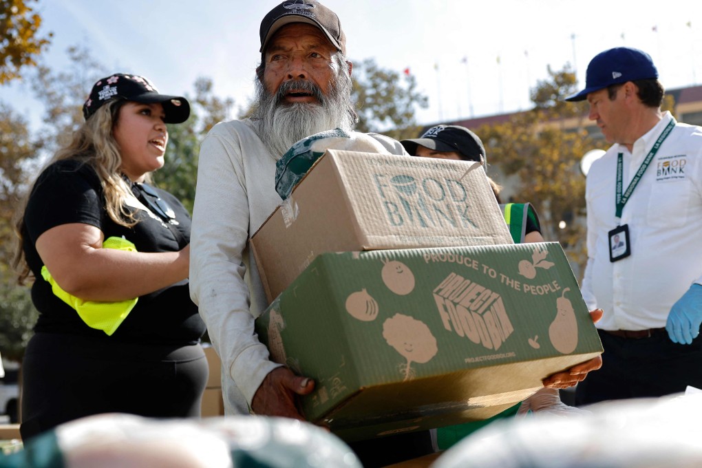 A man carries away food boxes being distributed in Los Angles, California, on Tuesday in response to the Snap benefit delays. Photo: AFP