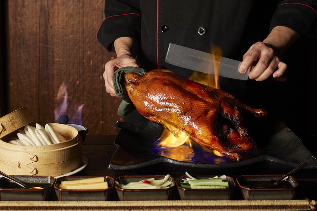 The signature Peking duck at Hong Kong’s Hutong restaurant is flamed and carved at the table. Photo: Hutong