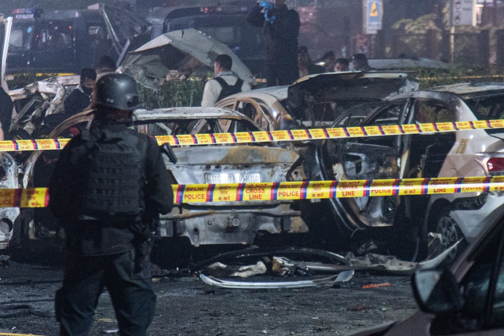 Security personnel inspect the site, where a car explosion had taken place near the Red Fort monument in New Delhi. Photo: dpa