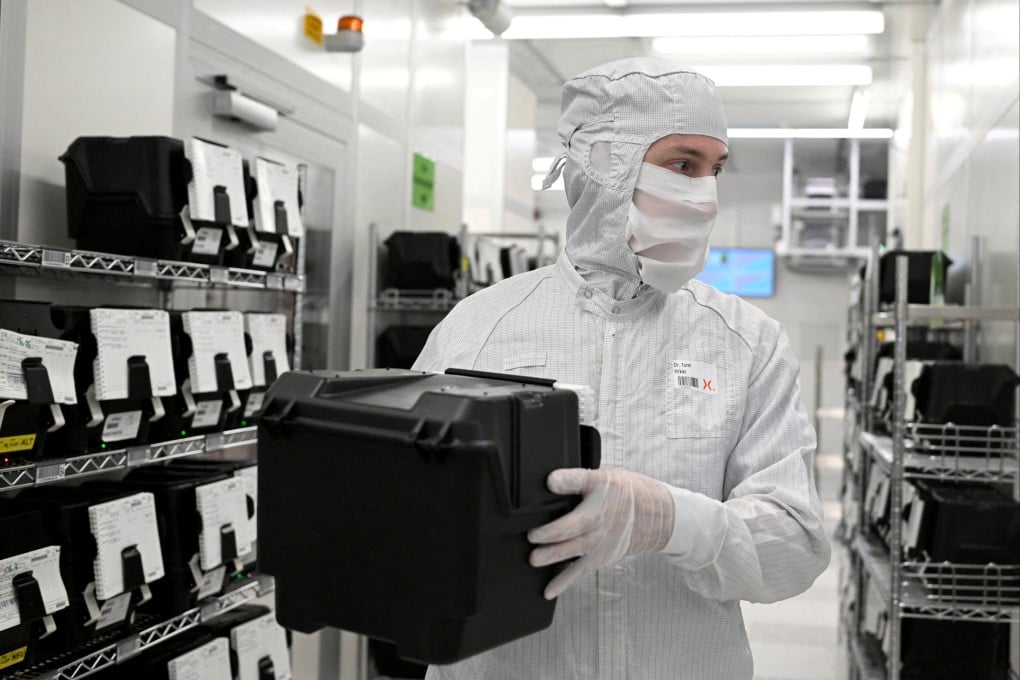 An employee holds a box with wafers in a production line of Dutch semiconductor company Nexperia in Hamburg, Germany, on June 27, 2024. Photo: Reuters