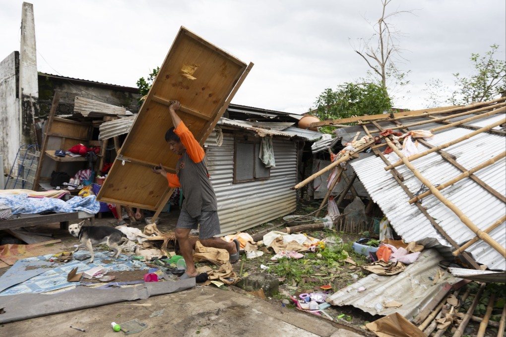People return to a house damaged by Typhoon Fung-wong in Isabela province, northern Philippines, on Monday. Photo: EPA