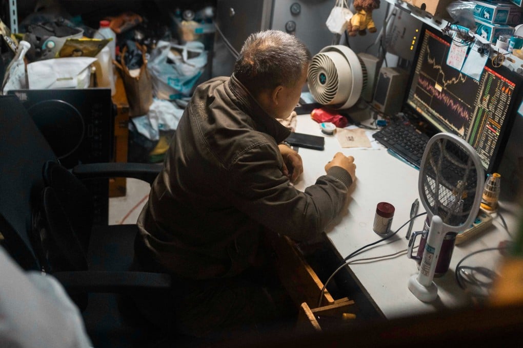 A man checks the latest stock exchange data on a computer screen at his shop in Shanghai on October 30. Photo: EPA