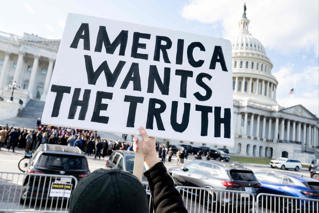 A protester holds a sign related to the release of the Jeffrey Epstein case files outside the US Capitol in Washington. Photo: AFP
