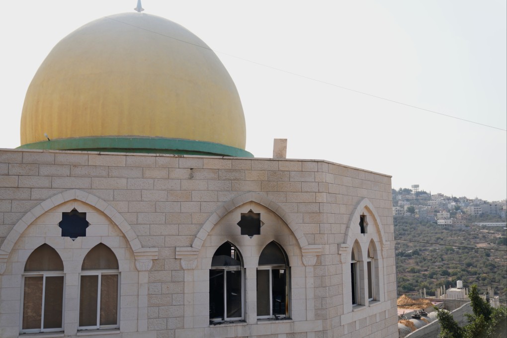 Damaged windows and walls of a mosque that was torched and defaced by Israeli settlers in the West Bank town of Deir Istiya on Thursday. Photo: AP