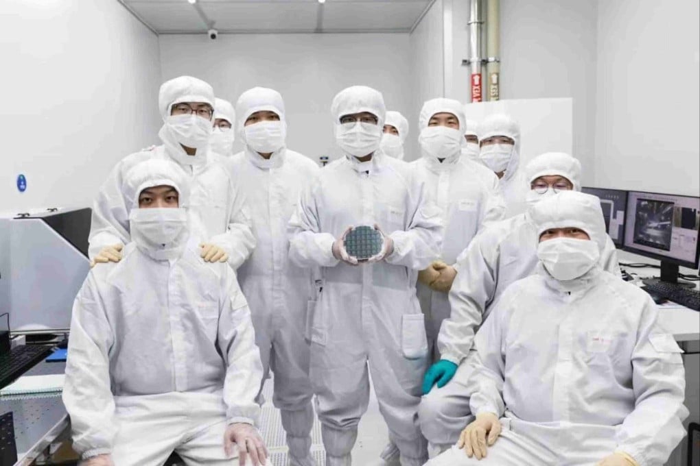 Researchers at CHIPX pose for a photo with their high-performance 6-inch thin-film lithium niobate chip, an advance that is poised to accelerate progress in AI and quantum computing. Photo: Handout