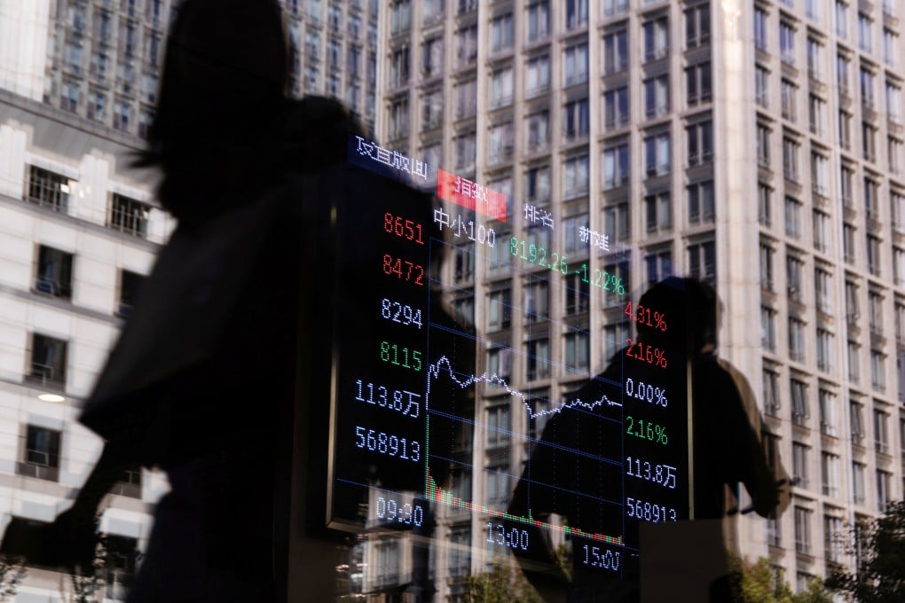 People pass the window of a brokerage house where a screen displays stock index information in Beijing on October 13, 2025. Photo: Reuters