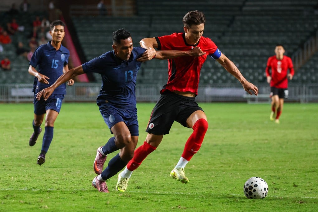 Matt Orr fends off Krya Saret during Hong Kong’s 1-1 draw with Cambodia. Photo: Edmond So