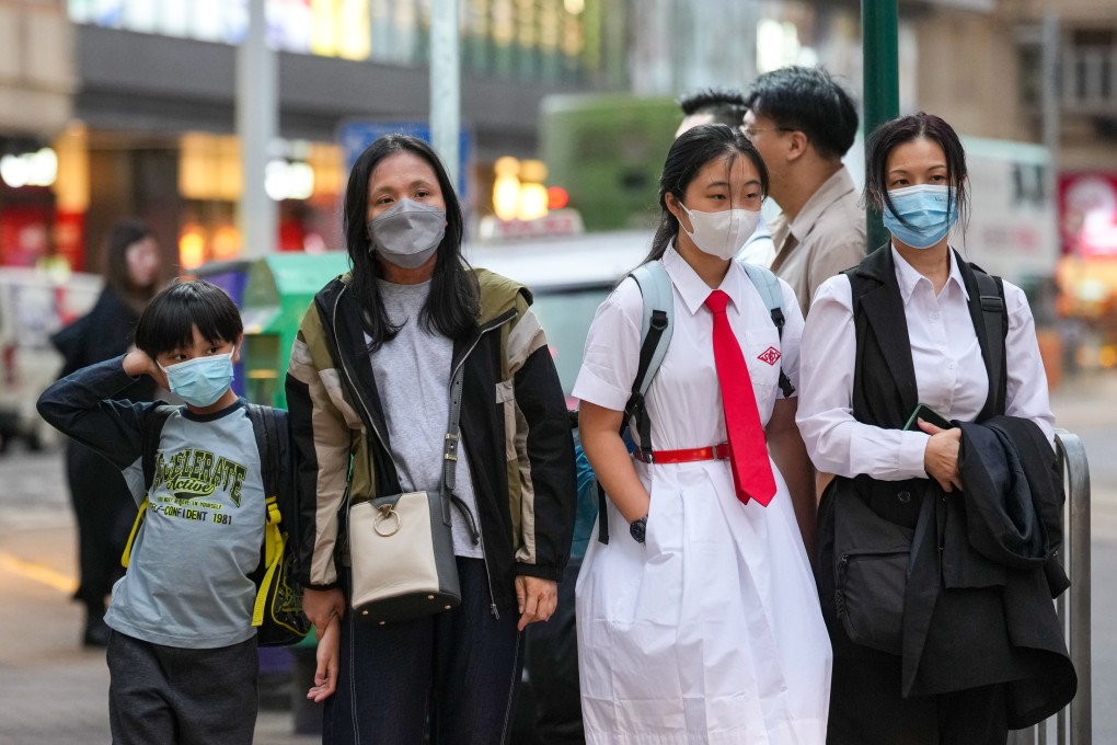 People wear masks in Kennedy Town as a precaution against the flu. Photo: Karma Lo
