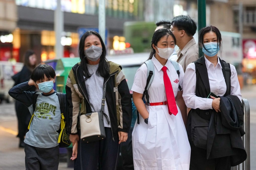 People wear masks in Kennedy Town as a precaution against the flu. Photo: Karma Lo