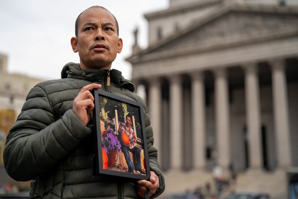 Yangeng Ge holds a photo of his brother, Chaofeng Ge, who died in a Pennsylvania ICE facility in August. The family has filed a lawsuit against the US government, seeking information about the circumstances of his death. Photo: Reuters