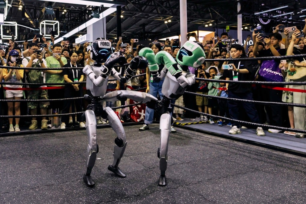 Visitors watch robots fight at the World Artificial Intelligence Conference in Shanghai, in July. Photo: EPA