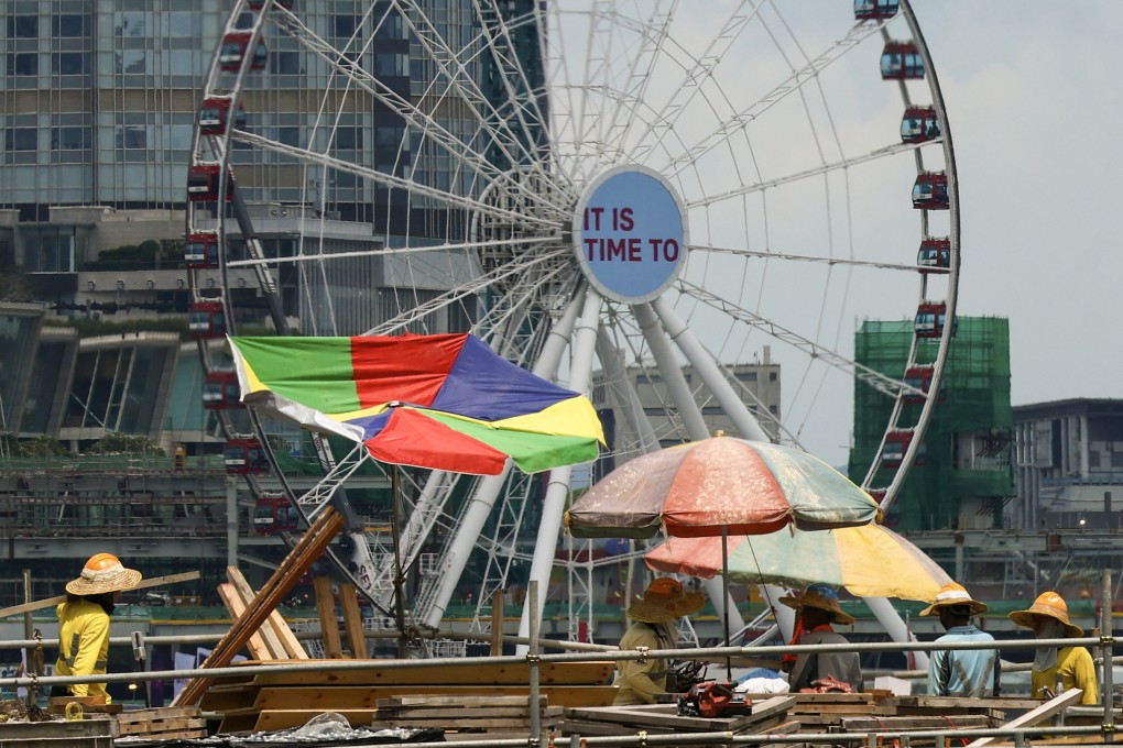 Construction workers put up large umbrellas in Wan Chai on May 23, when a very hot weather warning was issued. Hong Kong has suffered 50 to 60 hot nights (over 28 degrees) every year since 2020, compared with around 20 a year a decade earlier. Photo: Dickson Lee