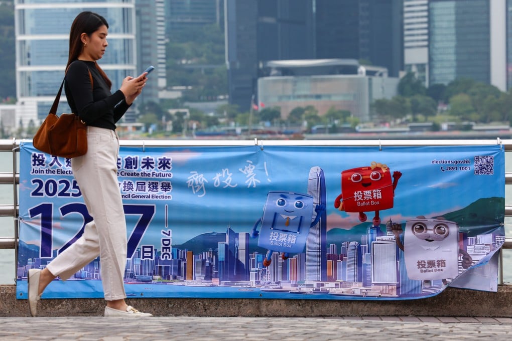 A woman walks past a poster for Hong Kong’s 2025 Legislative Council election, at the Tsim Sha Tsui Pier, on November 6. Photo: Jelly Tse
