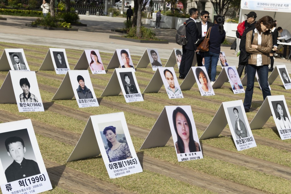 People look at pictures of North Koreans missing in North Korea during an exhibition in Seoul, South Korea, in October. Photo: EPA
