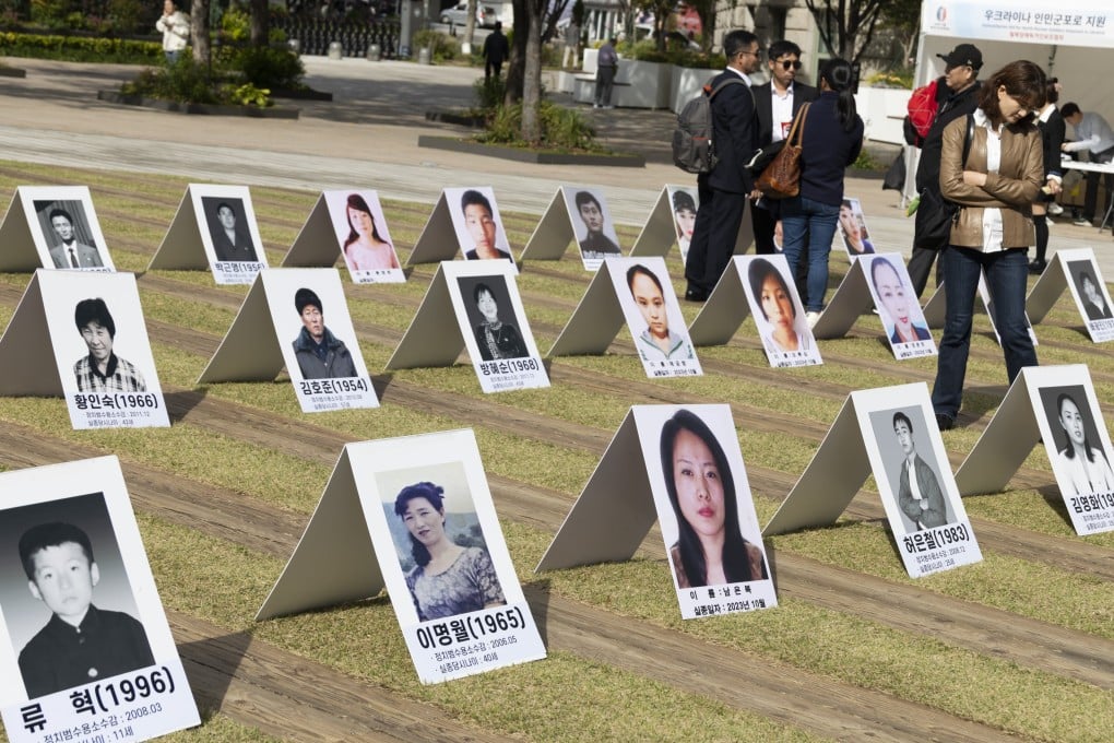 People look at pictures of North Koreans missing in North Korea during an exhibition in Seoul, South Korea, in October. Photo: EPA