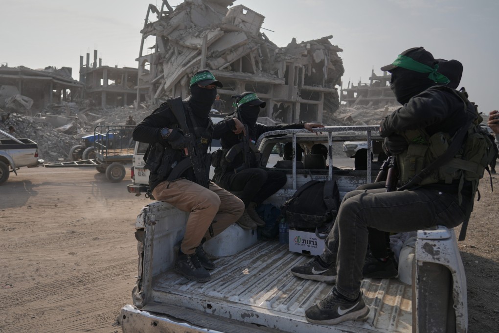 Hamas militants accompanied by members of the International Committee of the Red Cross head to east of Gaza City to search for the bodies of hostages on Thursday. Photo: AP