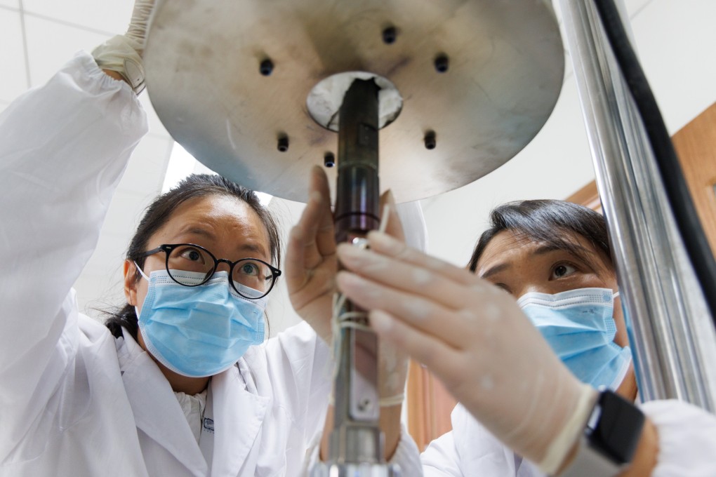 Researchers position an alloy material sample used in building a thorium molten salt reactor at a lab in Shanghai on October 23. Photo: EPA/Xinhua