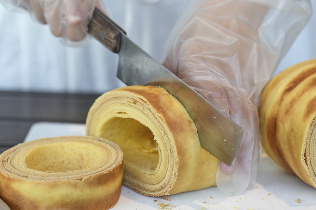 Baumkuchen, a German layered cake, is sliced during a workshop of Juchheim Ninoshima Welcome Center and Outdoor Activity Camp at Ninoshima island in Hiroshima, western Japan. Photo: AP