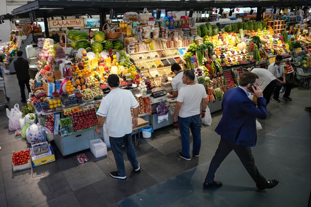 Sellers prepare vegetables for customers at a market in Moscow, Russia. Photo: AP