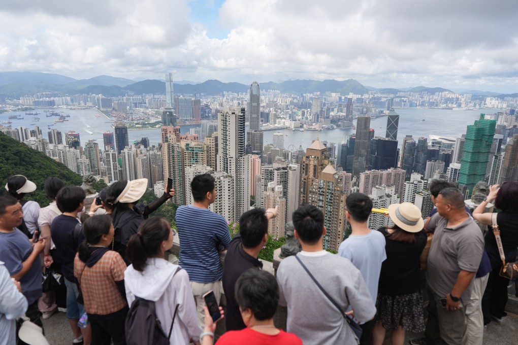Tourists take in the view of Hong Kong from The Peak on June 21, 2025. Photo: Eugene Lee