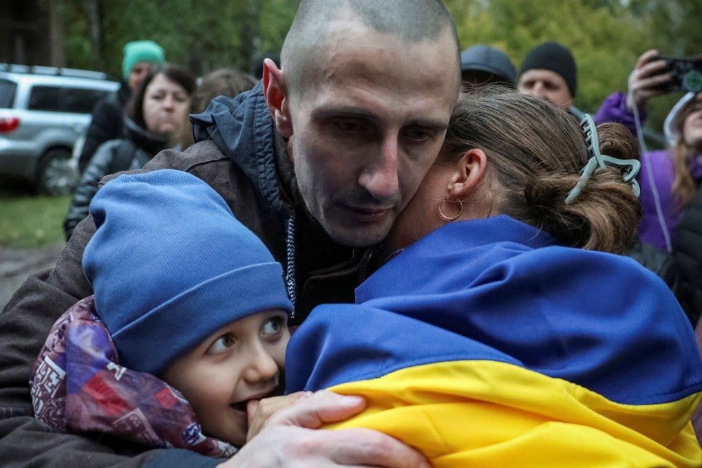 A freed Ukrainian prisoner of war mbraces his relatives after a swap of POWs, amid Russia’s attack on Ukraine, in an undisclosed location in Ukraine on October 2. Photo: Reuters