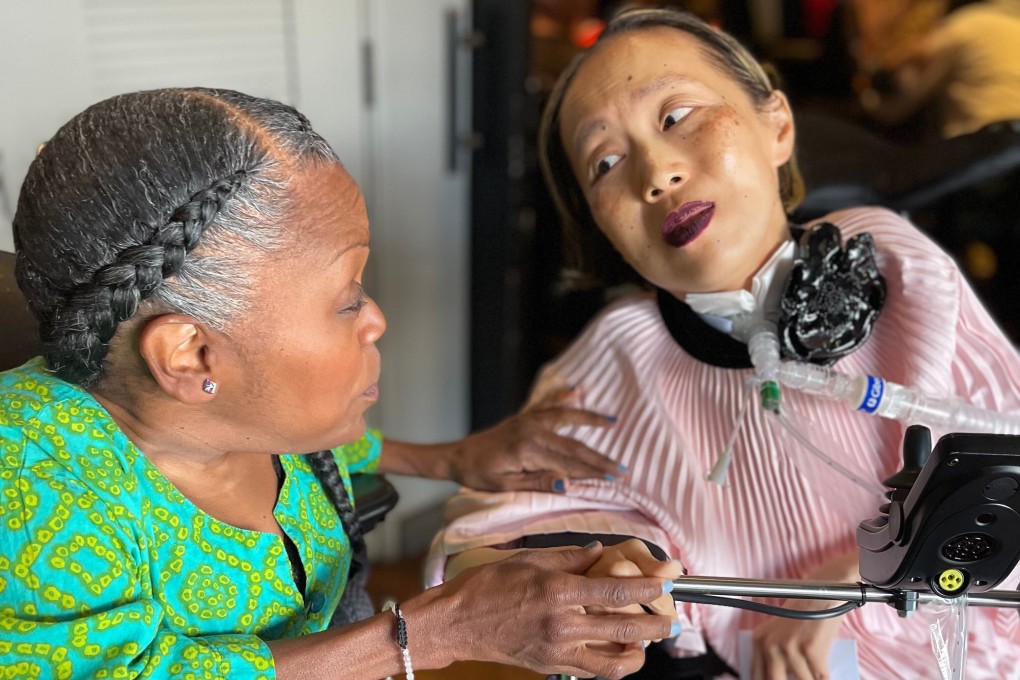 Alice Wong (right) speaks with Yomi Young during the activist’s 50th birthday party in San Francisco in March. Photo: Sandy Ho via AP