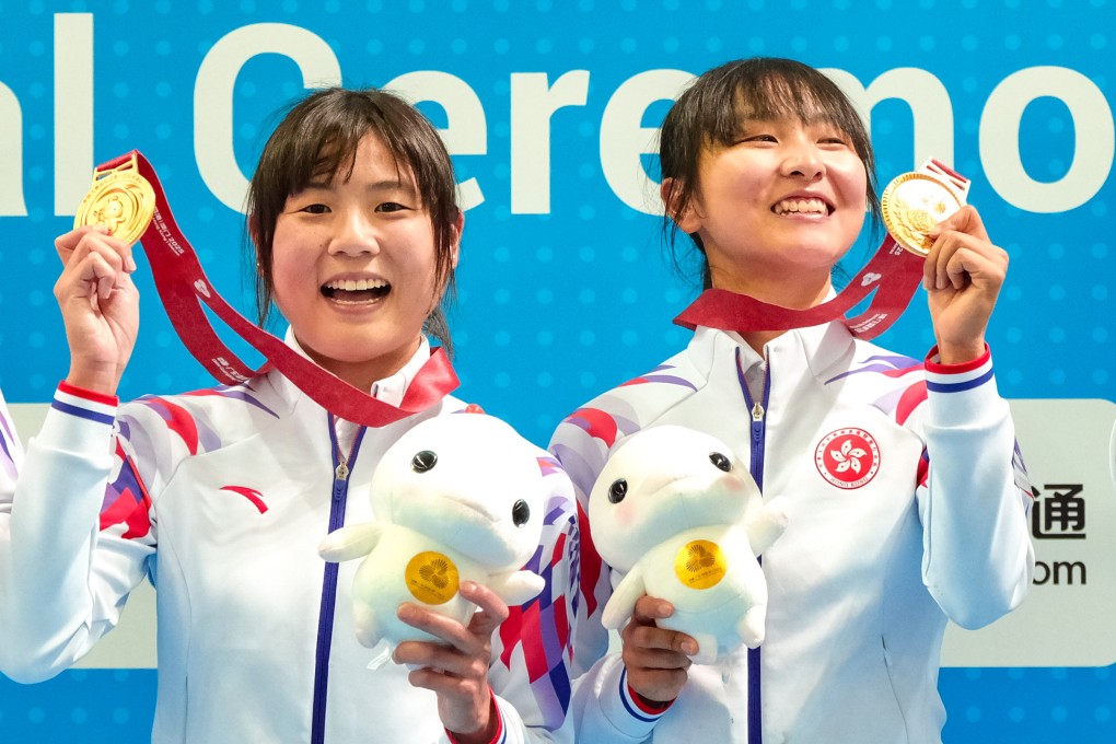 Hong Kong cyclists Chloe Leung and Ceci Lee stand on top of the podium after winning the Madison at Hong Kong Velodrome. Photo: Karma Lo