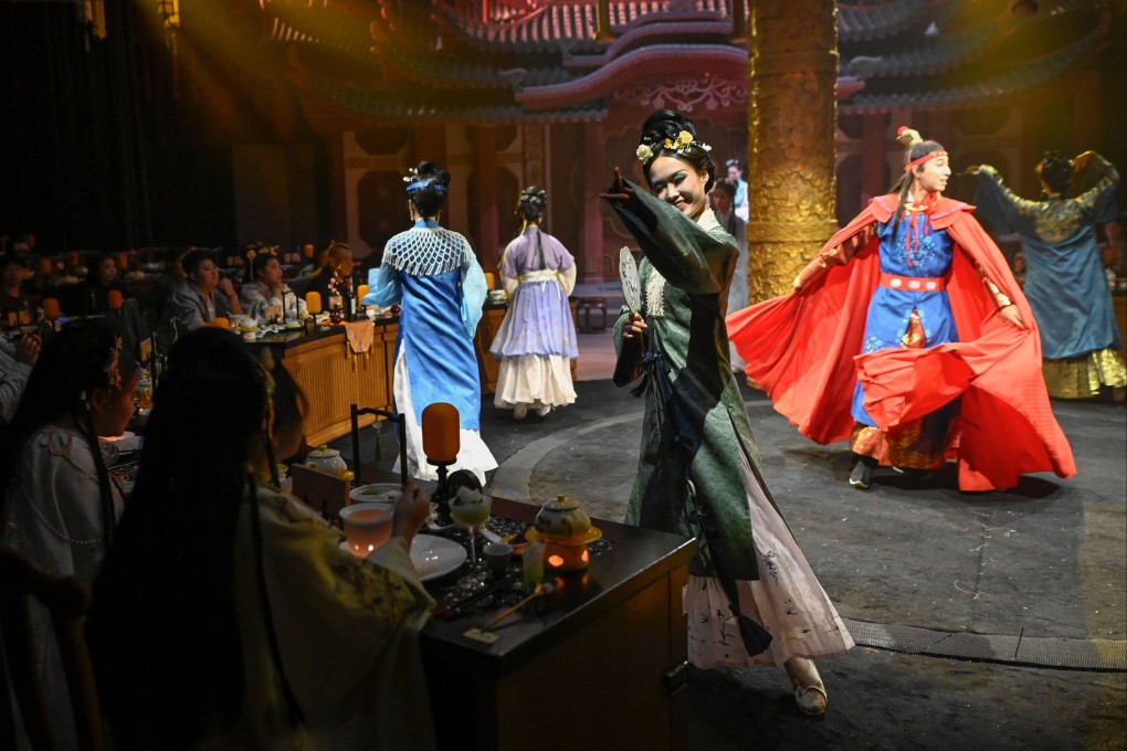 Artists in traditional Chinese clothing perform as customers enjoy their meals at Yan Wai Yan, a new theatrical restaurant in Beijing, China. Photo: AFP