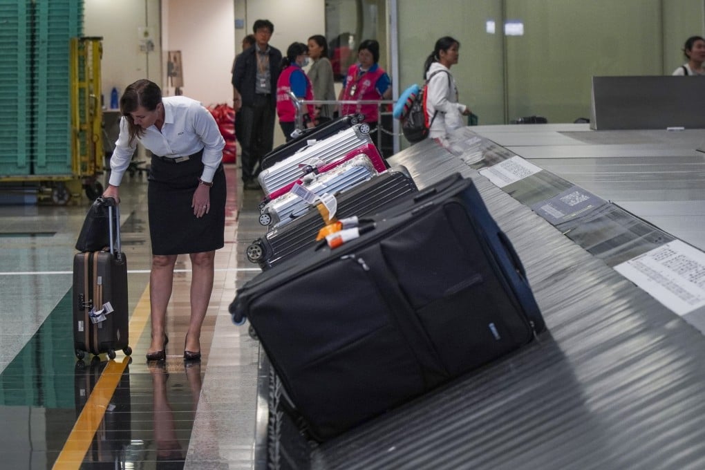 A traveller picks up her luggage at a baggage collection belt in Hong Kong International Airport. The Consumer Council notes 55 complaints over travel insurance claims were filed in the first 10 months of 2025. Photo: Roy Issa