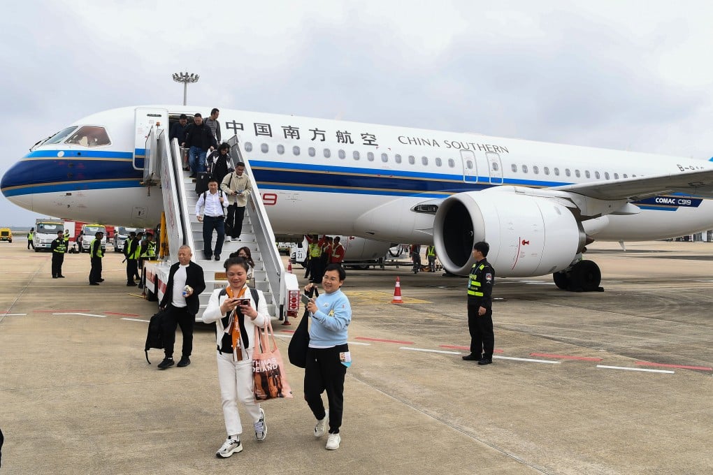 Passengers step off a C919 aircraft operated by China Southern Airlines at Haikou Meilan International Airport in Haikou, south China’s Hainan Province. Photo: Xinhua