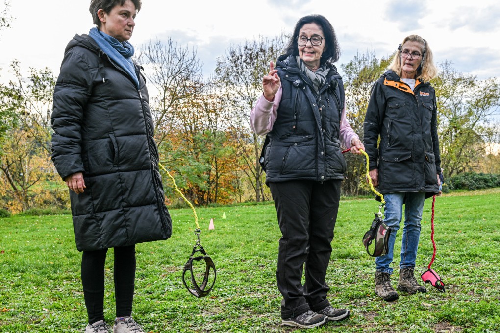 Dog trainer Barbara Gerlinger (centre) holds an empty dog leash while teaching “hobby dogging”, a viral trend of training imaginary dogs, to participants in one of her courses. Photo: dpa