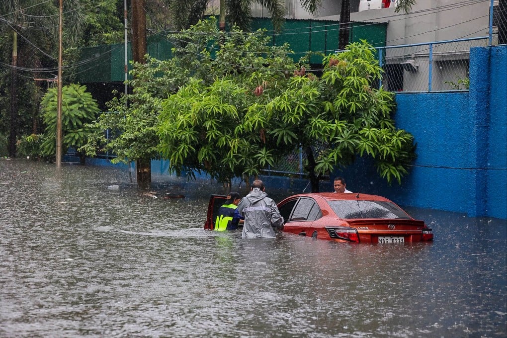 A car is seen partially submerged in floodwater in Quezon City, Philippines, in August. Photo: Xinhua
