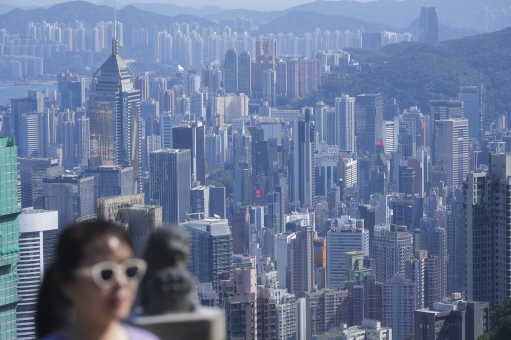 A woman walks on the Peak, with Hong Kong’s skyline in the background, on February 4. Photo: Sam Tsang