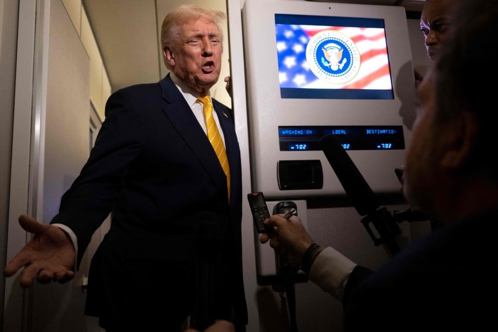US President Donald Trump speaks to reporters on board Air Force One on Friday while in flight from Washington to West Palm Beach International Airport. Photo: Getty Images via AFP