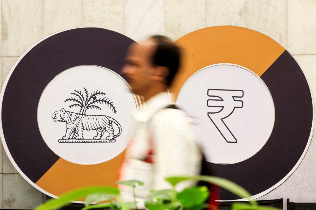 A man walks past logos of the Reserve Bank of India and the Indian rupee inside the central bank’s headquarters in Mumbai, India. Photo: Reuters