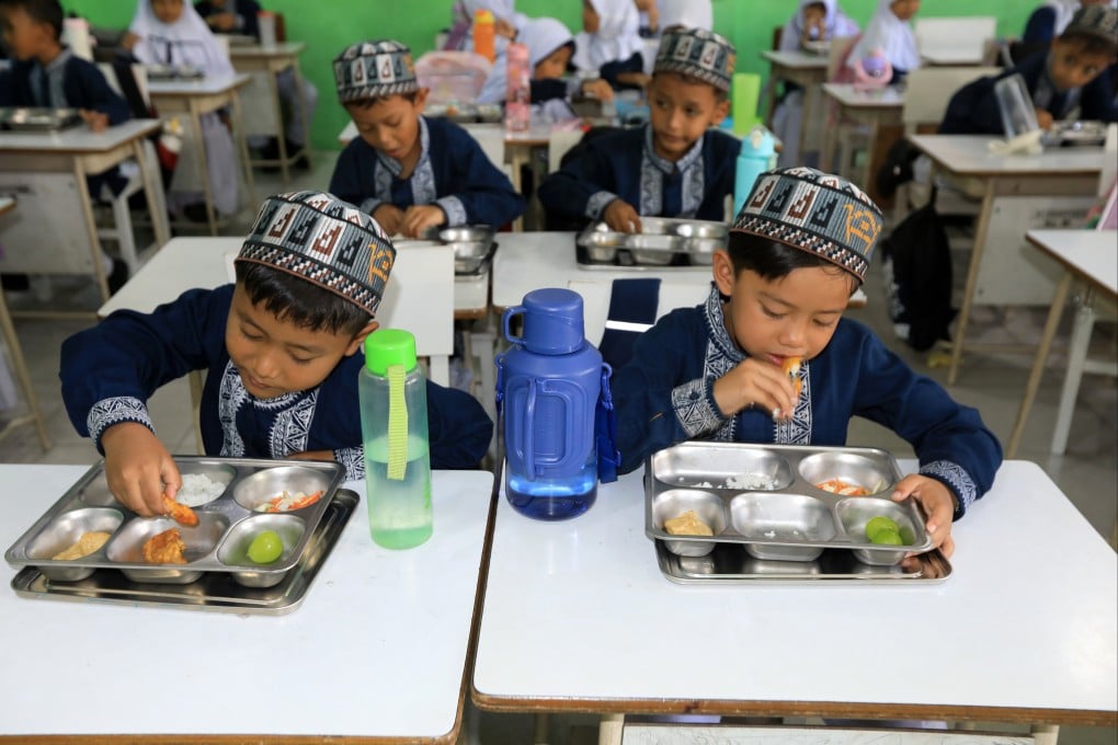 Indonesian pupils eat free meals at an elementary school in Banda Aceh in October. The programme’s rapid scale-up has revealed significant regulatory and quality-control gaps. Photo: EPA