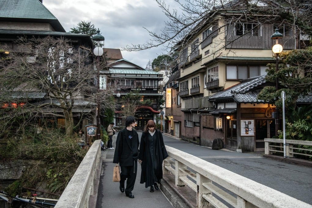 A couple walks over a bridge in the Japanese resort town of Hakone. China has advised its citizens to avoid travelling to Japan amid a diplomatic row between the two countries. Photo: Getty Images