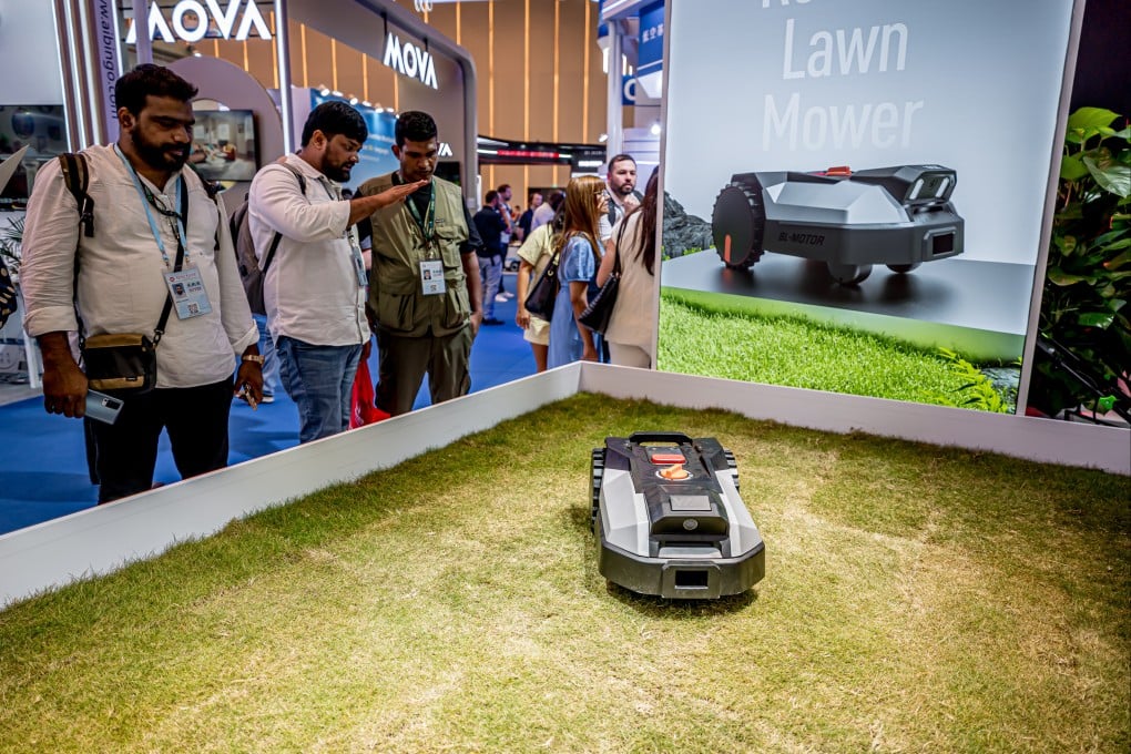Attendees view a robotic lawnmower at the 138th China Import and Export Fair in October. Photo: Getty Images