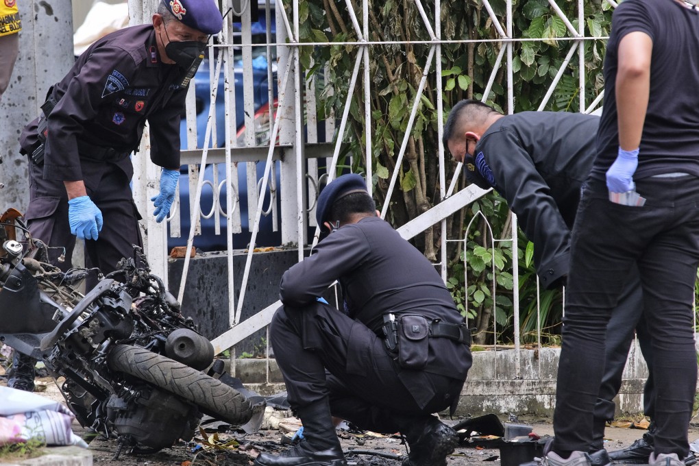 Members of a police bomb squad inspect the wreckage of a motorbike used to carry out a suicide attack in  South Sulawesi, Indonesia, on  March 29, 2021. Photo: AP