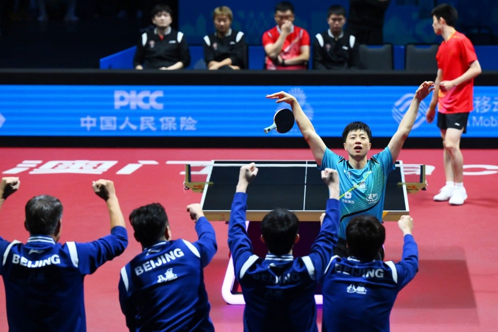 Ma Long of Beijing (middle right) celebrates his win over Zhou Kai of Shanghai, giving his team a 2-1 lead in the men’s team final at the National Games in Macau on Thursday. Photo: Xinhua