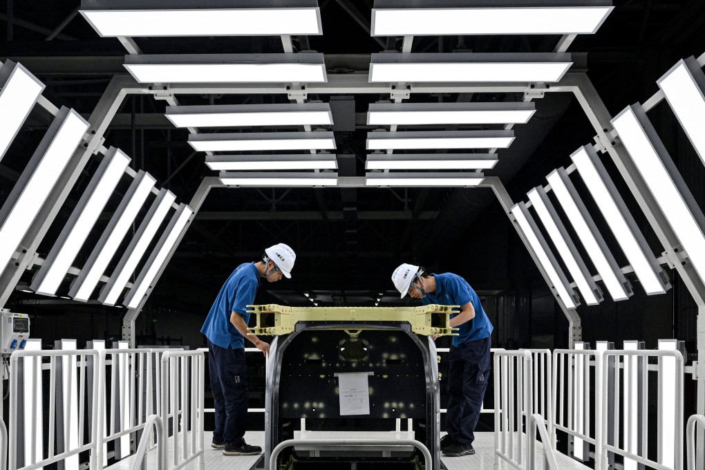 Employees work on a production line for an electric flying car at a factory of Xpeng’s subsidiary Aridge in Guangzhou on November 6. Photo: AFP