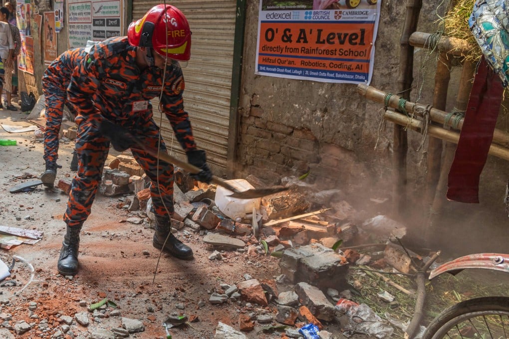 Rescuers clear debris from a roof and wall collapse after an earthquake in Dhaka, Bangladesh, on Friday. Photo: AP
