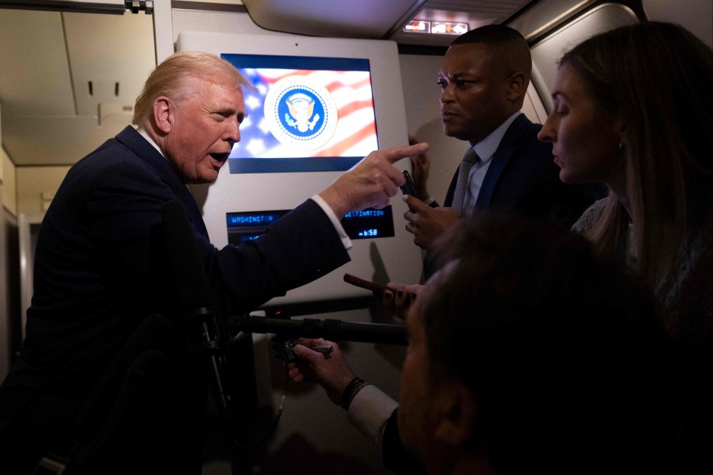 US President Donald Trump speaks to members of the press aboard Air Force One on November 14. Photo: AFP