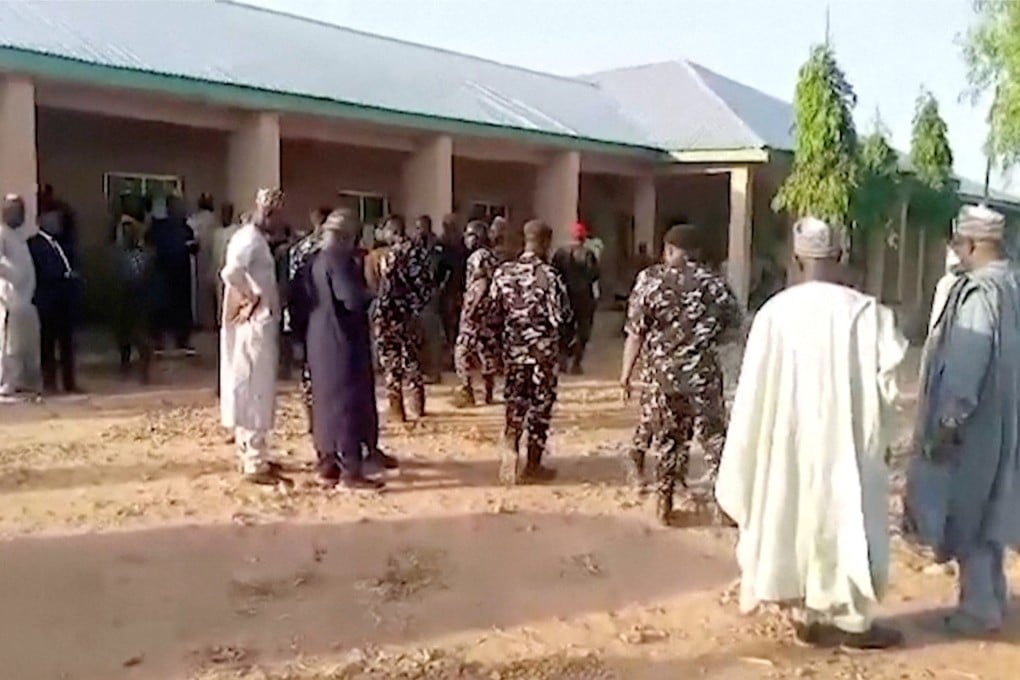 Nigerian government officials and police officers inspect a school compound after gunmen attacked a government girls’ boarding school on Monday. Photo: Africa Independent Television/Reuters