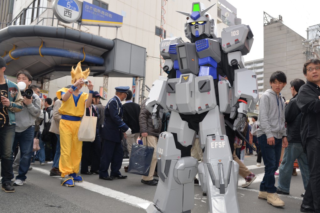 Cosplayers dressed as Goku and a Gundam character at the Nippombashi Street Festa in Osaka. Such fan-driven events reflect the deep-rooted pop-culture communities that oshikatsu has helped bring further into the mainstream. Photo: Xinhua
