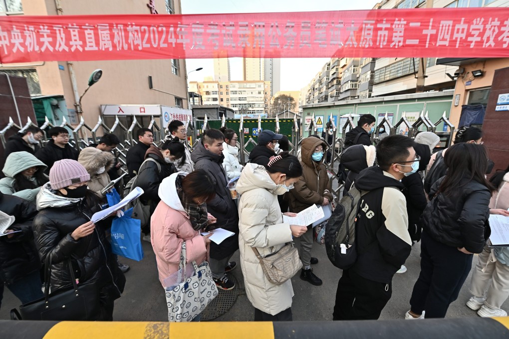 Candidates for the civil service exam wait outside a testing centre in central China. The “iron rice bowl” jobs are highly prized. Photo: Getty Images